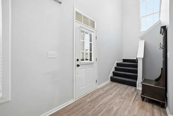 a view of a livingroom with wooden floor and stairs