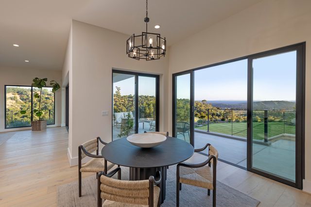 a living room with furniture a table and a chandelier