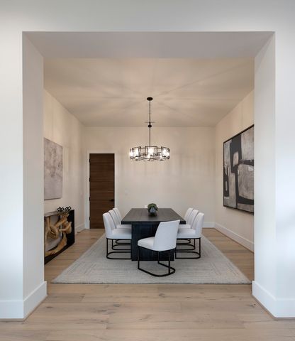 a view of a dining room with furniture and chandelier