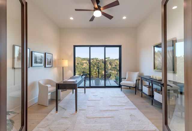 a view of a hallway with entryway and stairs