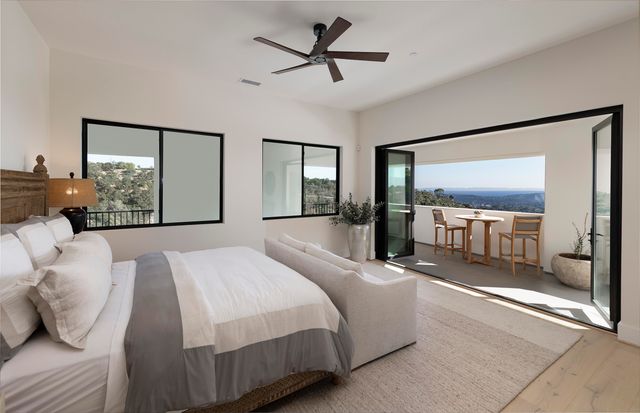 a view of a dining room with furniture and a floor to ceiling window
