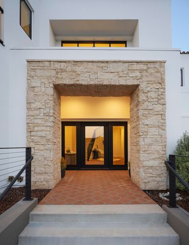 a living room with furniture kitchen and a chandelier