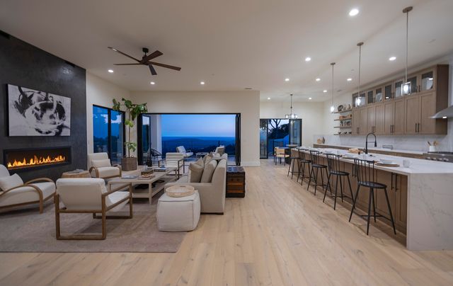a living room with furniture and kitchen view