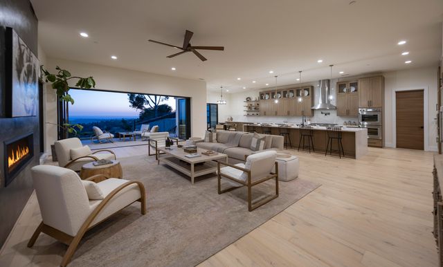 a large white kitchen with a large counter top appliances and cabinets