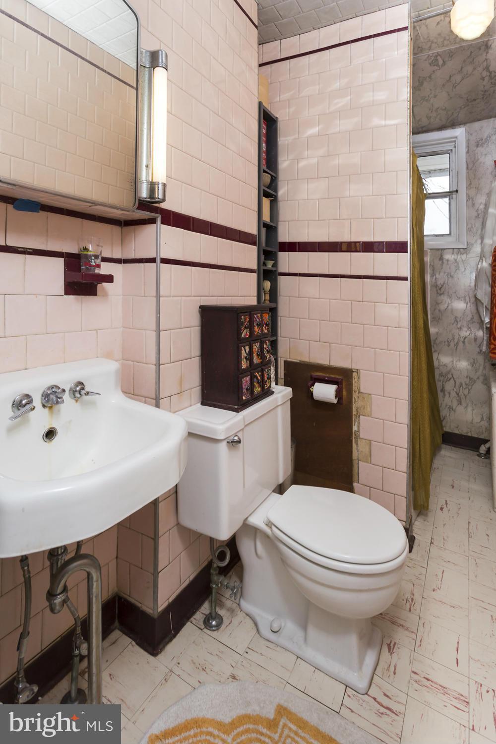 108 Rochester Place Baltimore, MD 21224 - Photo 17 of 24 a white toilet sitting next to a bathroom sink