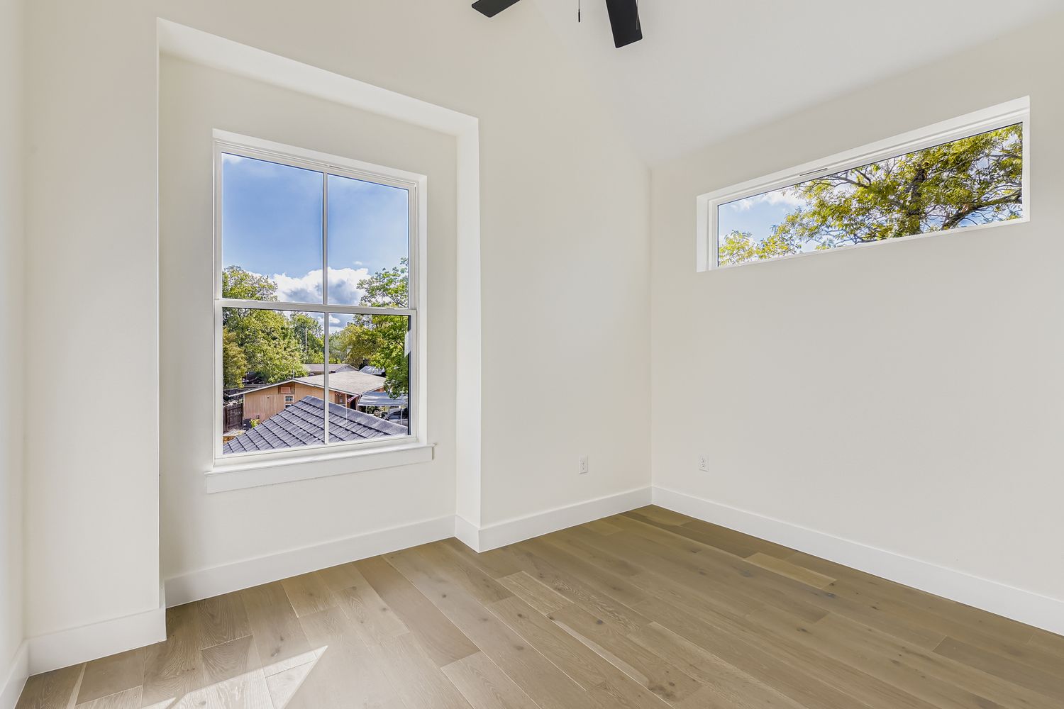 4712 South Forest Drive Austin, TX 78745 - Photo 19 of 27 a view of an empty room with wooden floor and a window