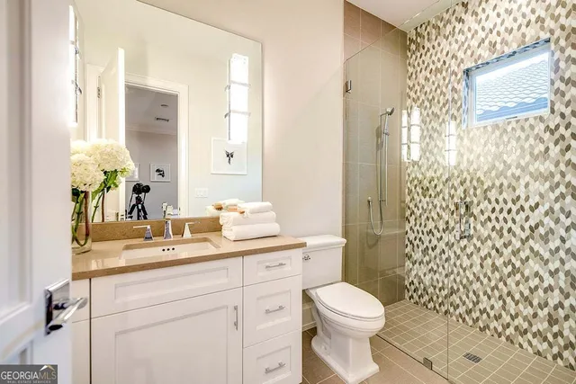 a bathroom with a sink a toilet and shower curtain