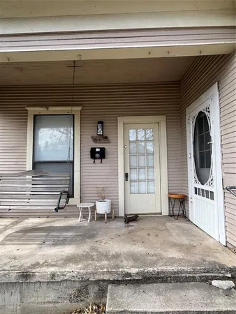a view of a livingroom with wooden floor and furniture