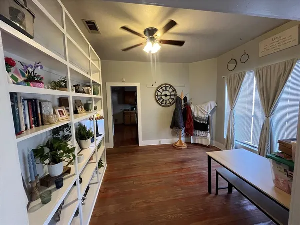 a view of a room with lots of stuff and hardwood floor