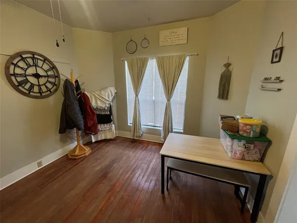 a view of a workspace with furniture and wooden floor