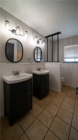 a bathroom with a double vanity sink and mirror