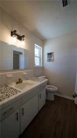 a view of bathroom with a toilet sink and mirror