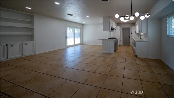 a view of a kitchen with a sink and a chandelier
