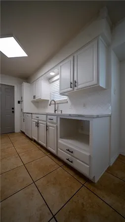 a kitchen with stainless steel appliances a sink stove and cabinets