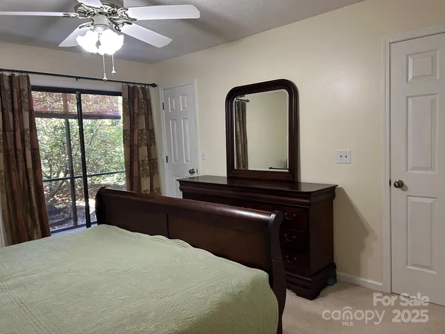 a bedroom with a bed and a large window