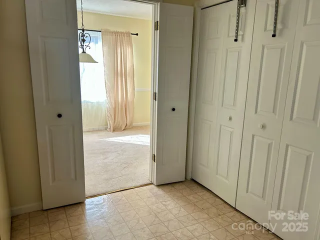 a view of a hallway with a door in a bathroom