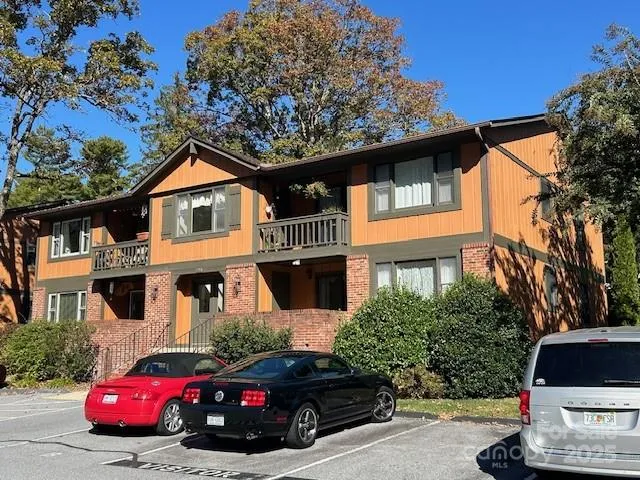 a car parked in front of a white house