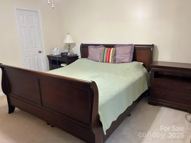 a bedroom with bed and window