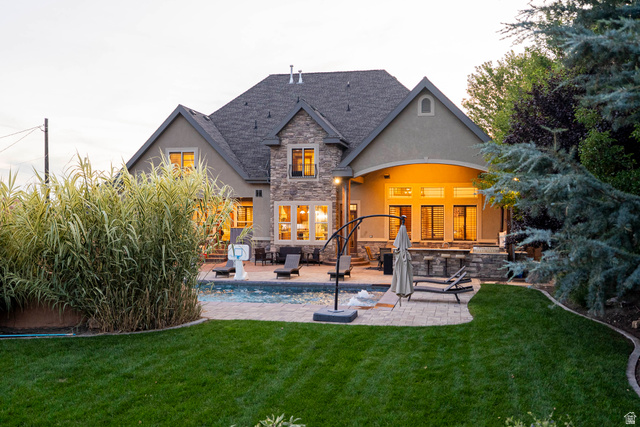 687 South 2080th Street East Springville, UT 84663 - Photo 136 of 149 Expansive backyard featuring a manicured lawn, mature landscaping, and a paver patio surrounding an in-ground swimming pool