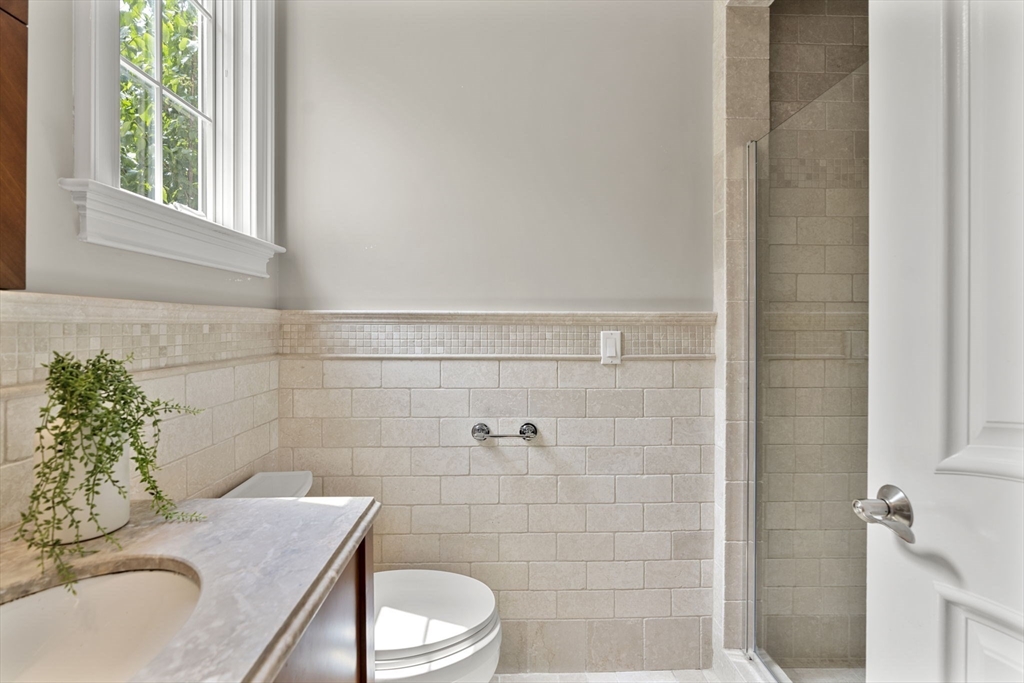 22 Scotney Road Newton, MA 02467 - Photo 24 of 42 a bathroom with a sink a toilet and a mirror