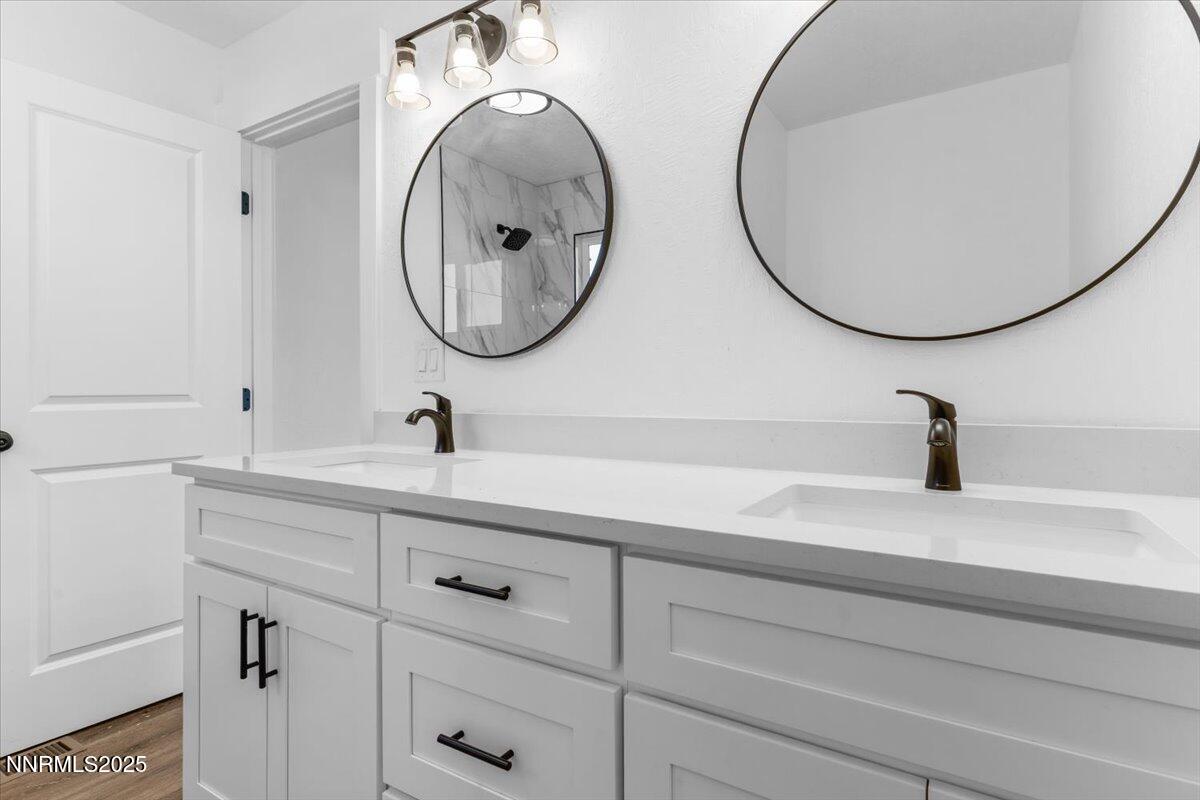 10655 Silver Spur Drive Reno, NV 89508 - Photo 11 of 34 a bathroom with a sink and a mirror