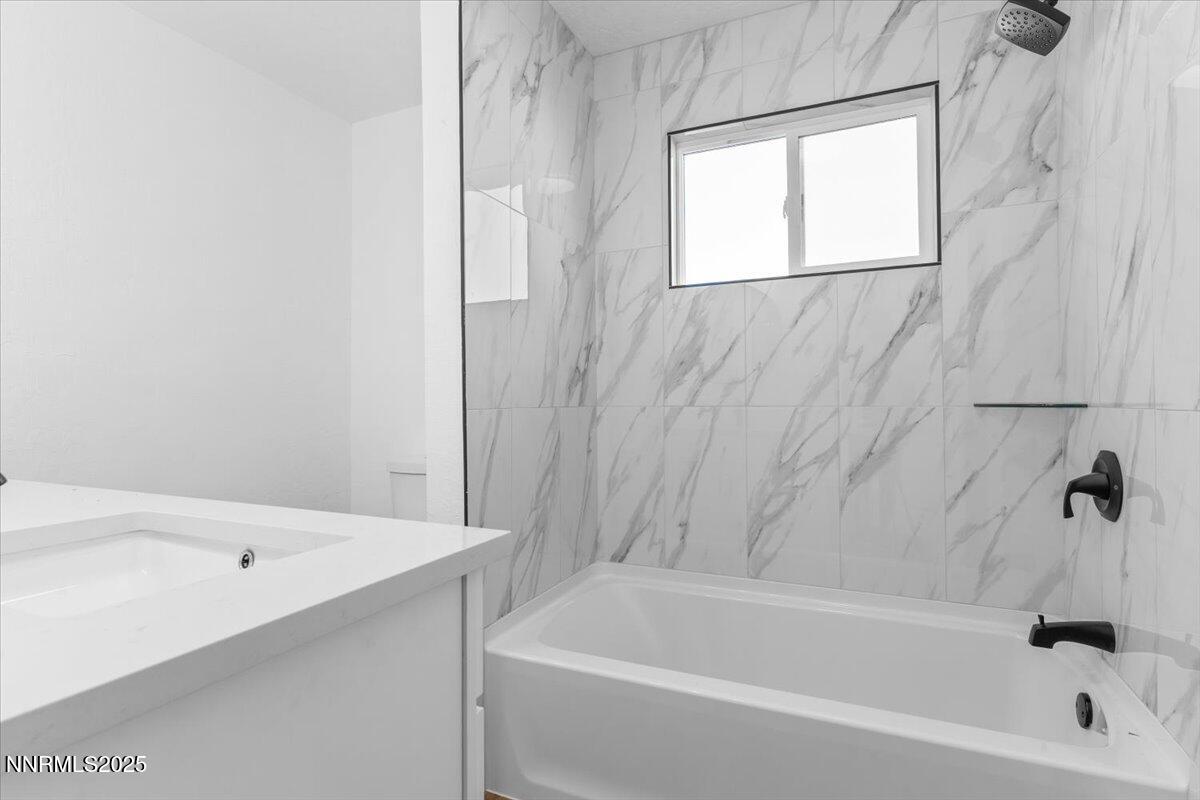 10655 Silver Spur Drive Reno, NV 89508 - Photo 13 of 34 a bathroom with a bathtub and a shower