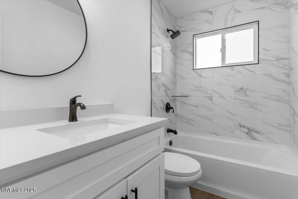 10655 Silver Spur Drive Reno, NV 89508 - Photo 19 of 34 a bathroom with a sink a toilet and a bathtub