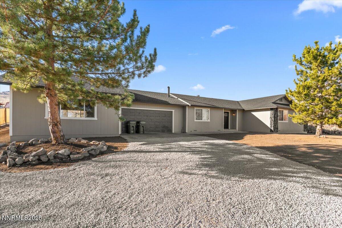 10655 Silver Spur Drive Reno, NV 89508 - Photo 3 of 34 a front view of a house with a yard