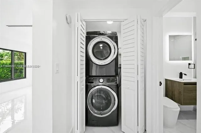 a utility room with sink dryer and washer