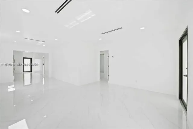 an empty room with closet and windows