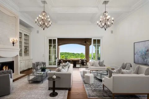 a kitchen with white cabinets and sink