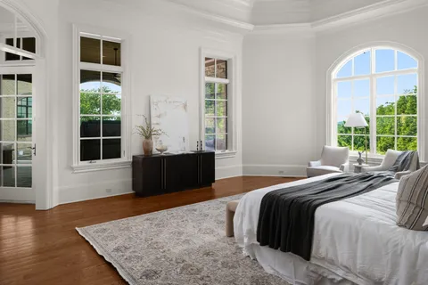 a bathroom with a granite countertop sink a toilet a mirror and shower
