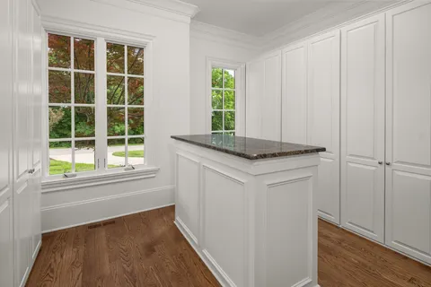a view of a dining room with furniture and a floor to ceiling window