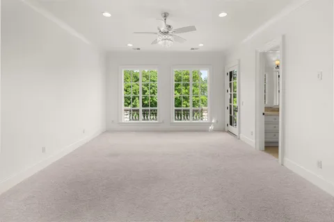 an aerial view of residential houses with outdoor space and trees