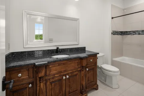 a view of a big house with a big yard and large trees