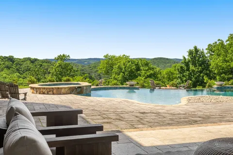 a dining room with furniture and a chandelier