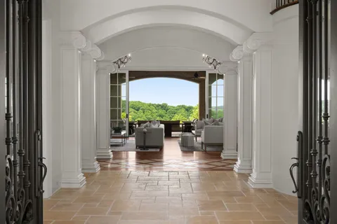 a living room with furniture a chandelier a fireplace and a chandelier