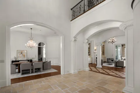 a living room with furniture a fireplace and a chandelier