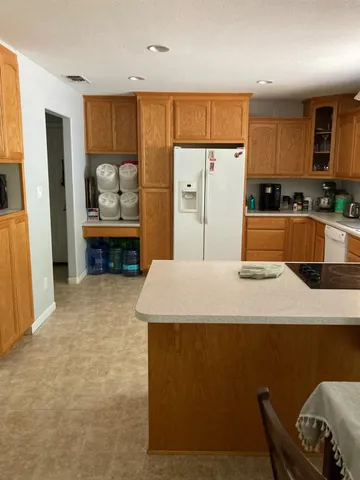 a living room with furniture a fireplace and a chandelier