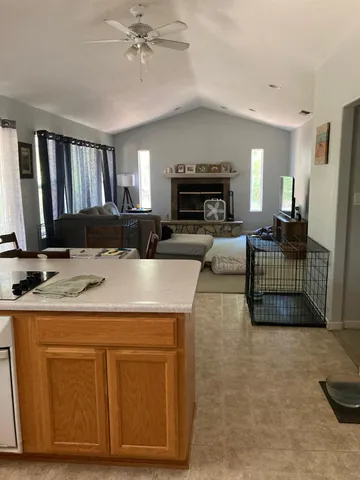 a view of a house with backyard sitting area and garden