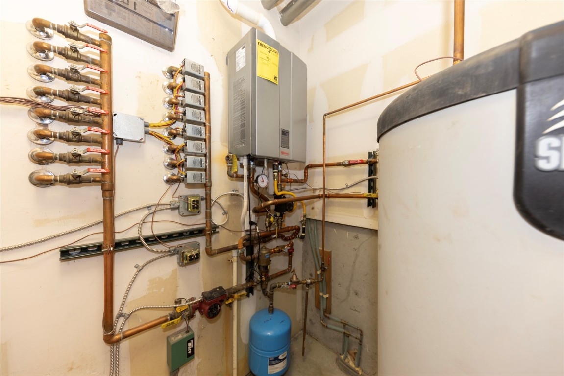 511 Ryan Gulch Road Wildernest, CO 80498 - Photo 24 of 37 Utility room featuring water heater and tankless water heater