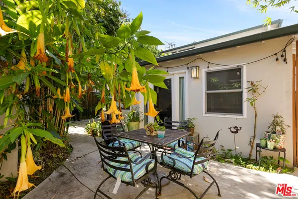 a backyard of a house with table and chairs