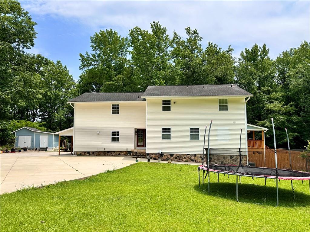 a view of a house with backyard porch and sitting area