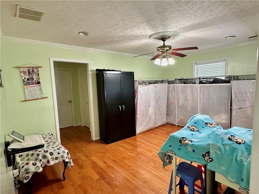 7326 Leland Lane Jonesboro, GA 30236 - Photo 13 of 18 a bedroom with a bed and a chandelier