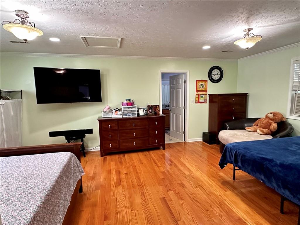 7326 Leland Lane Jonesboro, GA 30236 - Photo 14 of 18 a bedroom with a bed and flat screen tv