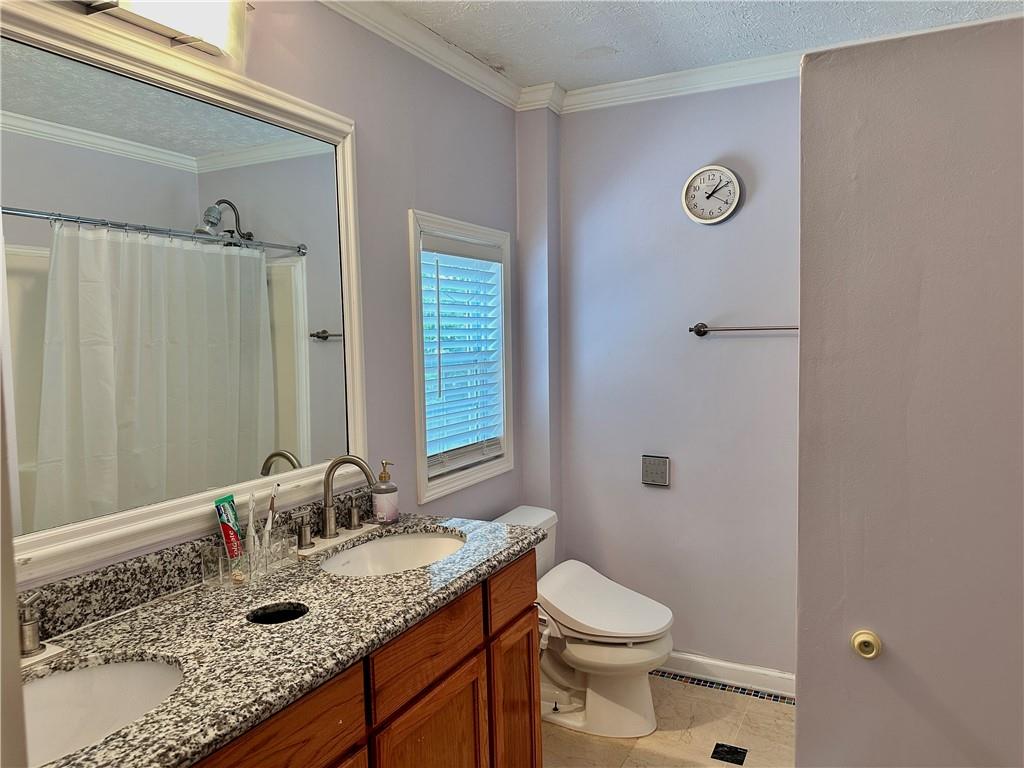 7326 Leland Lane Jonesboro, GA 30236 - Photo 15 of 18 a bathroom with a granite countertop sink and a mirror