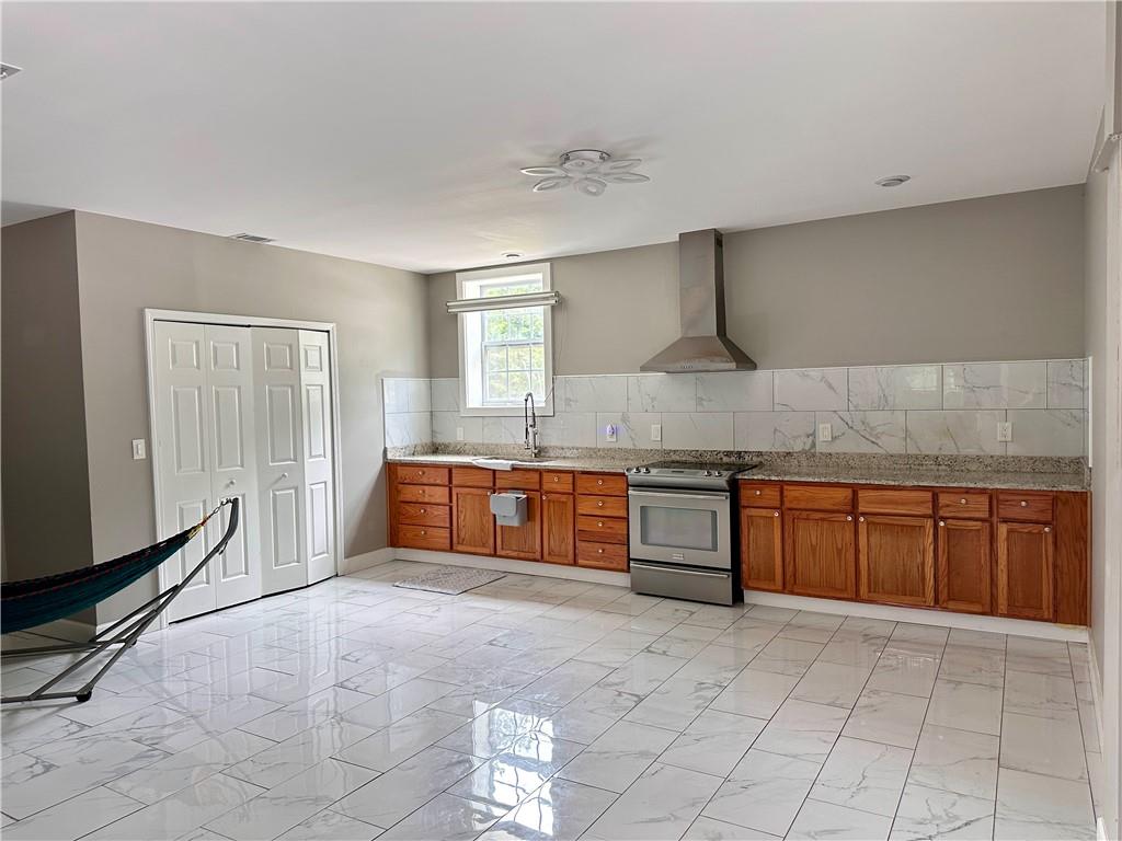 7326 Leland Lane Jonesboro, GA 30236 - Photo 3 of 18 a large kitchen with stainless steel appliances granite countertop a sink and cabinets