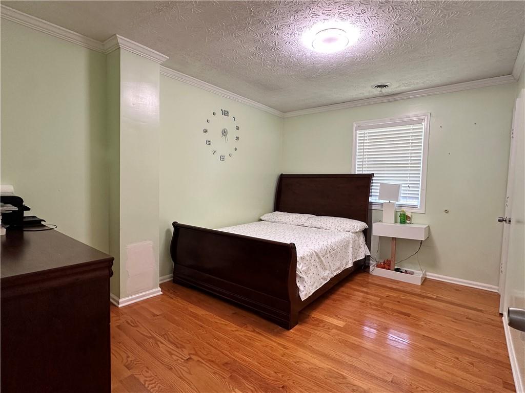 7326 Leland Lane Jonesboro, GA 30236 - Photo 10 of 18 a bedroom with a bed and wooden floor