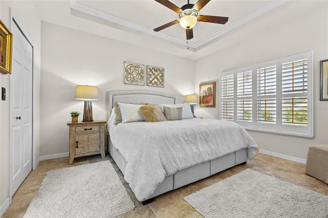 a bedroom with a large bed and a chandelier