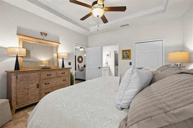 a bedroom with a bed and a chandelier